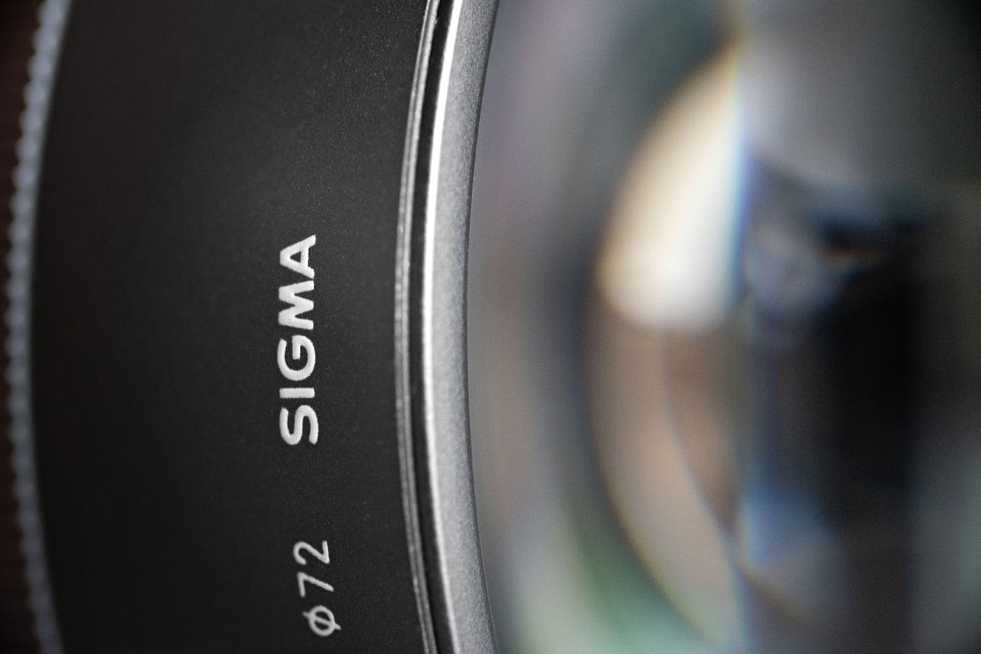 A macro photograph of a camera lens showing its glass elements
