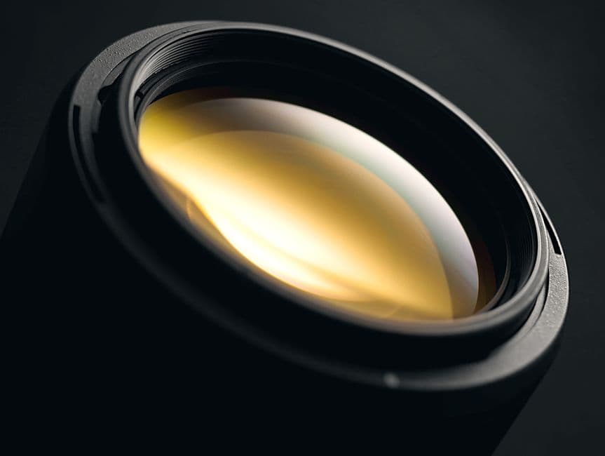A close-up of a lens showing its reflective glass coating