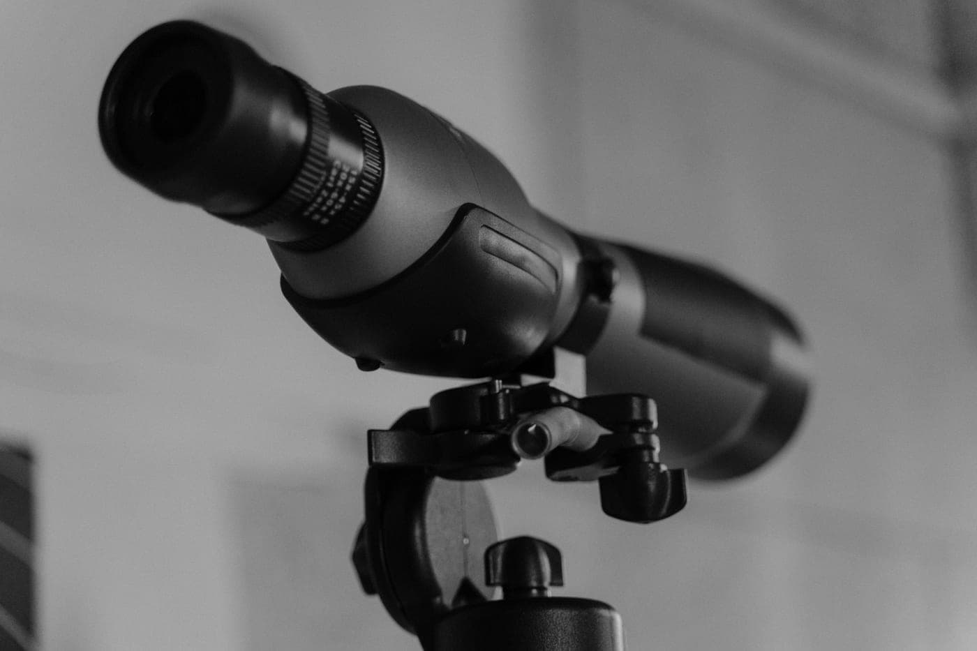 A close-up of a telescope objective lens mounted on a tripod