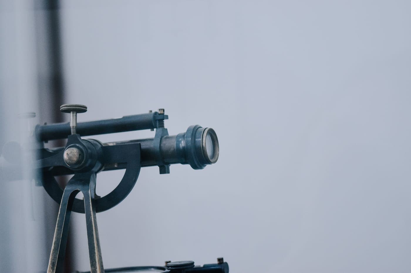 A close-up of a telescope lens and its metal housing