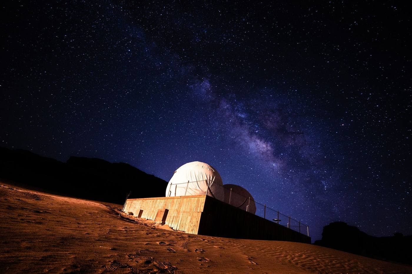 The Milky Way arching above a desert observatory