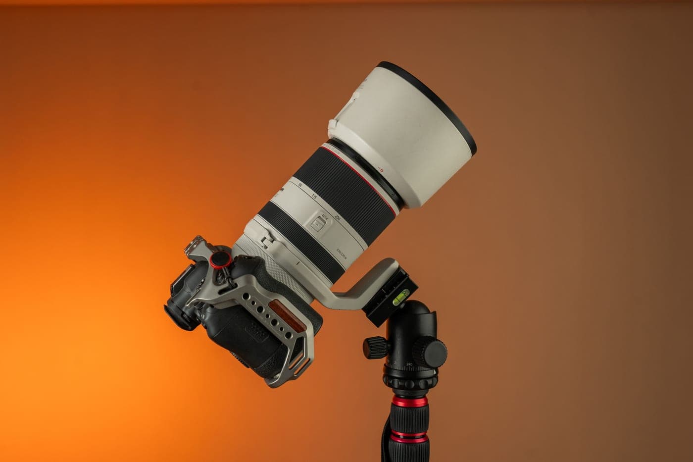 A long lens mounted on a tripod head, photographed close up