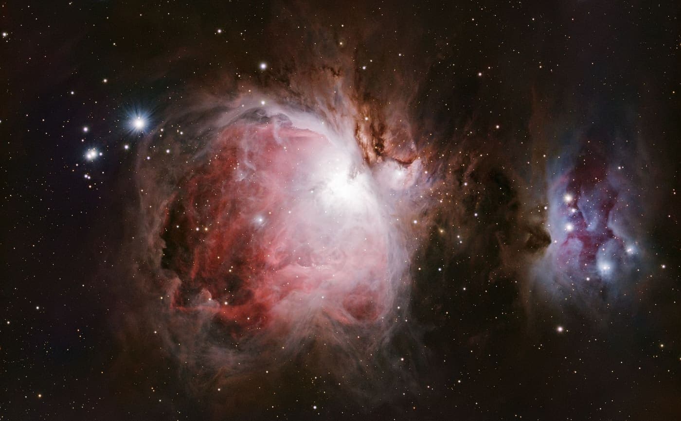 An astrophotograph of the Orion Nebula, which is a long exposure rather than an eyepiece view