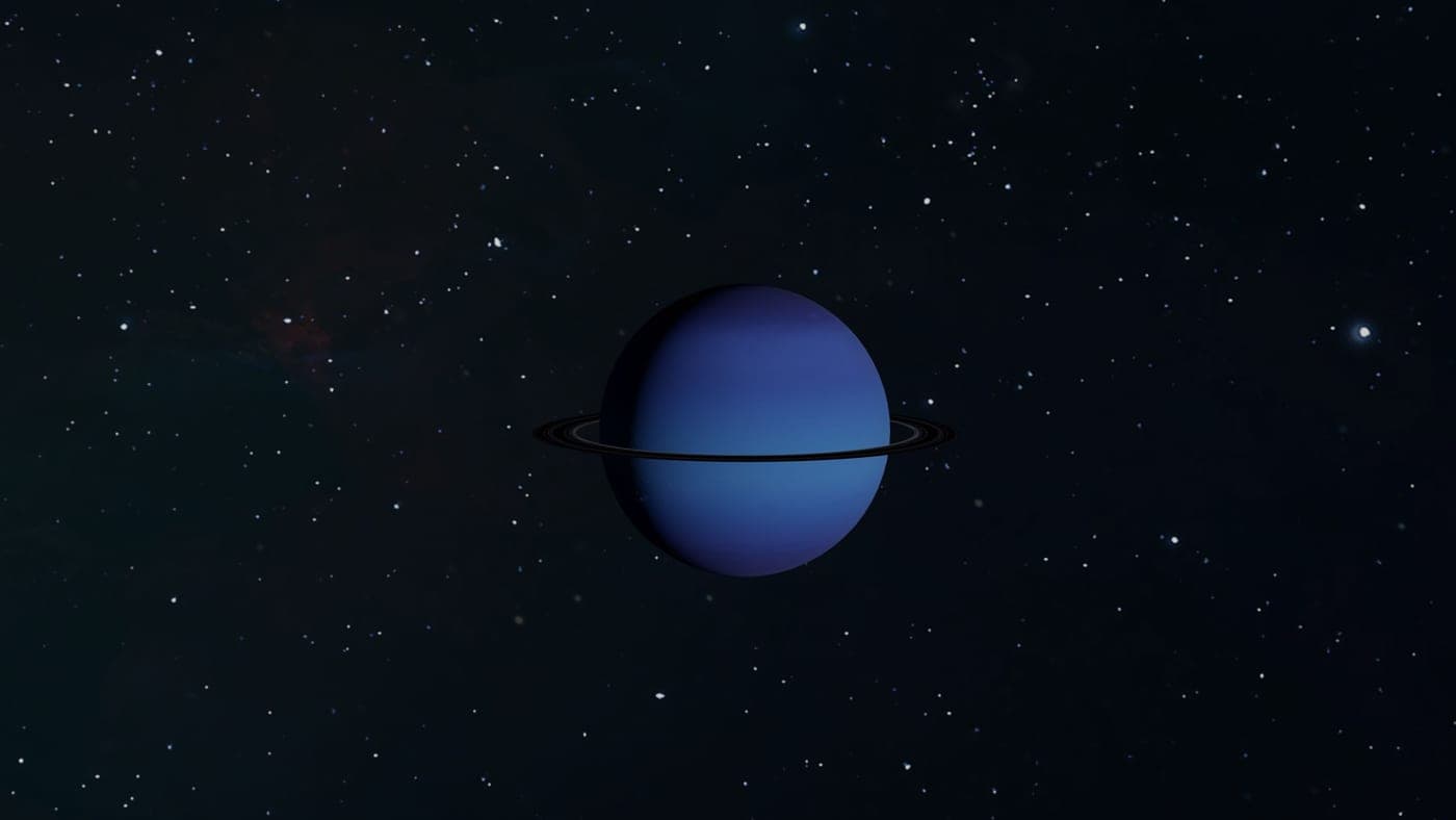 A space photograph of a ringed planet against a starfield, not an eyepiece view