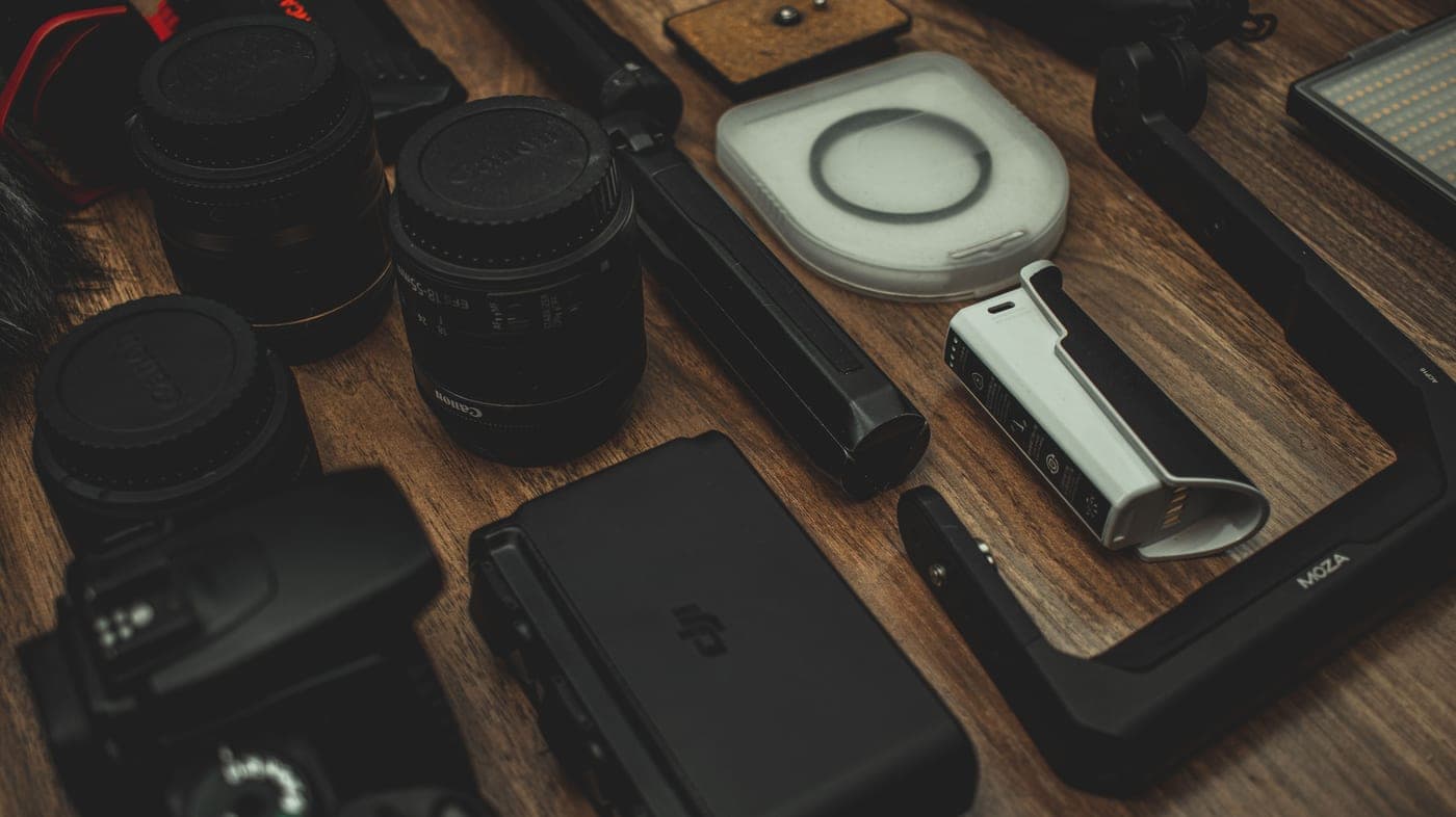 Lenses, filters and small optical accessories arranged on a wooden surface